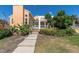 Beautiful home exterior featuring a private, screened-in patio and lush landscaping with walkway at 19 Crescent S Pl, St Petersburg, FL 33711