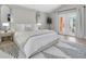 Serene bedroom with a king-size bed, neutral tones, and a private balcony at 19 Crescent S Pl, St Petersburg, FL 33711