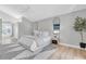 Calm bedroom featuring neutral decor, a stylish mirror, and ample natural light at 19 Crescent S Pl, St Petersburg, FL 33711