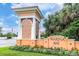 A stately entrance to Marina Bay features a decorative gatehouse, colorful flowers, and verdant landscaping at 19 Crescent S Pl, St Petersburg, FL 33711