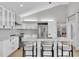 Modern kitchen with white cabinetry, stainless steel appliances, and a spacious island with seating at 19 Crescent S Pl, St Petersburg, FL 33711