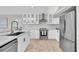 Modern kitchen featuring a stainless steel fridge, center island, and plenty of cabinet space at 19 Crescent S Pl, St Petersburg, FL 33711