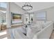 Comfortable living room with white sofa, a coastal painting, and a modern chandelier at 19 Crescent S Pl, St Petersburg, FL 33711