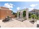 Outdoor patio area with pergola, table, chairs, and serene backyard views at 19 Crescent S Pl, St Petersburg, FL 33711