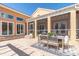 Spacious patio with outdoor dining and seating areas, enclosed porch, and landscaping at 19 Crescent S Pl, St Petersburg, FL 33711