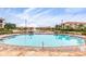 Community pool with a beautiful lake view, fountain, lounge chairs, and tropical landscaping for relaxation at 19 Crescent S Pl, St Petersburg, FL 33711