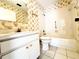 Cozy bathroom with flowered wallpaper, classic fixtures, and white tile flooring at 203 Rickenbacker Dr, Sun City Center, FL 33573