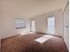 Bright bedroom featuring neutral carpet, large windows, and a spacious closet at 203 Rickenbacker Dr, Sun City Center, FL 33573