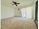 Bedroom boasting a ceiling fan, vertical blinds, and carpeted floor at 203 Rickenbacker Dr, Sun City Center, FL 33573