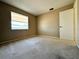 Neutral-toned bedroom with plush carpet, window with blinds, and a white closet door at 203 Rickenbacker Dr, Sun City Center, FL 33573