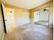 Bedroom showcasing neutral walls, sliding mirror closet, and an entrance to the hallway at 203 Rickenbacker Dr, Sun City Center, FL 33573