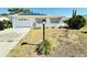 Charming single-story home featuring a well-maintained front yard and a one car garage at 203 Rickenbacker Dr, Sun City Center, FL 33573