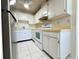 Functional kitchen featuring white cabinetry, tile backsplash, and laminate countertops at 203 Rickenbacker Dr, Sun City Center, FL 33573