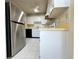 Efficient kitchen featuring white cabinets, stainless steel appliances, and ample counter space at 203 Rickenbacker Dr, Sun City Center, FL 33573