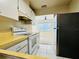 Cozy kitchen with laminate countertops, white appliances, and easy access to the living area at 203 Rickenbacker Dr, Sun City Center, FL 33573