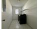 Laundry room featuring tile flooring, washer and dryer, and a window at 203 Rickenbacker Dr, Sun City Center, FL 33573