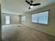 Bright living room boasting neutral walls and carpet, fan, and abundant natural light at 203 Rickenbacker Dr, Sun City Center, FL 33573
