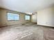 Expansive living room with neutral carpet, ceiling fan, and large windows at 203 Rickenbacker Dr, Sun City Center, FL 33573