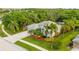 Aerial shot showcasing the property's well-maintained landscaping, spacious driveway, and tiled roof at 211 Royal Bonnet Dr, Apollo Beach, FL 33572