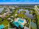 Aerial view of a community with a resort-style pool, playground, ponds, sports courts and lush landscaping at 211 Royal Bonnet Dr, Apollo Beach, FL 33572