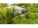 Aerial view of the screened-in pool and lanai, nestled among mature landscaping for added privacy at 211 Royal Bonnet Dr, Apollo Beach, FL 33572