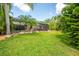 Lush backyard featuring tropical landscaping and a screened-in pool area perfect for outdoor entertaining at 211 Royal Bonnet Dr, Apollo Beach, FL 33572