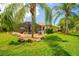 Tropical backyard oasis featuring a screened-in lanai, lush landscaping, and a serene setting at 211 Royal Bonnet Dr, Apollo Beach, FL 33572