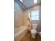 Neutral bathroom featuring a bathtub and shower combination with a white shower curtain and a toilet at 211 Royal Bonnet Dr, Apollo Beach, FL 33572