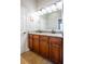 Bathroom with a double sink vanity, framed mirror, and wood cabinets, providing ample storage at 211 Royal Bonnet Dr, Apollo Beach, FL 33572