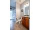 Neutral bathroom with a wood vanity, granite countertop and shower with coral design on the curtain at 211 Royal Bonnet Dr, Apollo Beach, FL 33572