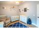 Charming Bedroom with crib, rocker, and space-themed decor accents at 211 Royal Bonnet Dr, Apollo Beach, FL 33572