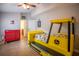 Fun bedroom featuring a tractor bed, red tool chest and tile flooring at 211 Royal Bonnet Dr, Apollo Beach, FL 33572