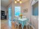 Cozy breakfast nook features a lovely table setting with white chairs and tile flooring at 211 Royal Bonnet Dr, Apollo Beach, FL 33572