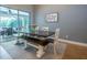 Dining room with a long dark wooden table, bench, and sliding glass doors at 211 Royal Bonnet Dr, Apollo Beach, FL 33572