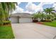 Charming home featuring a three-car garage and a well-maintained lawn, creating an inviting curb appeal at 211 Royal Bonnet Dr, Apollo Beach, FL 33572