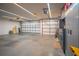 Well-lit, spacious garage with multiple doors and organized storage solutions, ideal for a workshop or car enthusiasts at 211 Royal Bonnet Dr, Apollo Beach, FL 33572