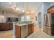 Open concept kitchen featuring granite counters, stainless steel appliances, and a view into the living area at 211 Royal Bonnet Dr, Apollo Beach, FL 33572