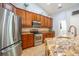 Charming kitchen boasts granite countertops, stainless steel appliances, ample storage, and tile flooring at 211 Royal Bonnet Dr, Apollo Beach, FL 33572