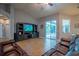 Spacious living room features tile floors, vaulted ceiling, and sliding glass doors to the pool area at 211 Royal Bonnet Dr, Apollo Beach, FL 33572