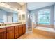 Spacious main bathroom features dual sinks, a soaking tub, and separate shower at 211 Royal Bonnet Dr, Apollo Beach, FL 33572