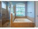 Beautiful main bathroom featuring a soaking tub and separate glass shower stall at 211 Royal Bonnet Dr, Apollo Beach, FL 33572