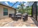 Screened in patio with comfortable seating and lush greenery, ideal for outdoor relaxation and entertaining at 211 Royal Bonnet Dr, Apollo Beach, FL 33572