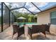 Screened-in lanai offering comfortable seating with a scenic view of the pool, perfect for relaxing and entertaining guests at 211 Royal Bonnet Dr, Apollo Beach, FL 33572