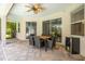 Covered patio with dining table, chairs, ceiling fan and beverage fridge, designed for relaxing and outdoor entertaining at 211 Royal Bonnet Dr, Apollo Beach, FL 33572