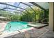 Sparkling pool with a spa and screened enclosure, creating a private oasis surrounded by greenery at 211 Royal Bonnet Dr, Apollo Beach, FL 33572