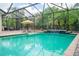 Enclosed pool featuring a waterfall, lounge chairs and nearby furniture, perfect for outdoor relaxation and entertainment at 211 Royal Bonnet Dr, Apollo Beach, FL 33572