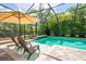 Covered pool area with clear blue water, lounge chairs, and serene tropical views at 211 Royal Bonnet Dr, Apollo Beach, FL 33572