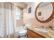Full bathroom with bathtub, shower, vanity, and round mirror at 25 Harbor Oaks Cir, Safety Harbor, FL 34695
