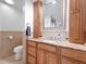 Bathroom with a granite countertop vanity, decorative mirror, and tiled flooring at 25 Harbor Oaks Cir, Safety Harbor, FL 34695