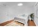 Cozy bedroom with a white bed, cloud light fixture, and ample natural light at 25 Harbor Oaks Cir, Safety Harbor, FL 34695